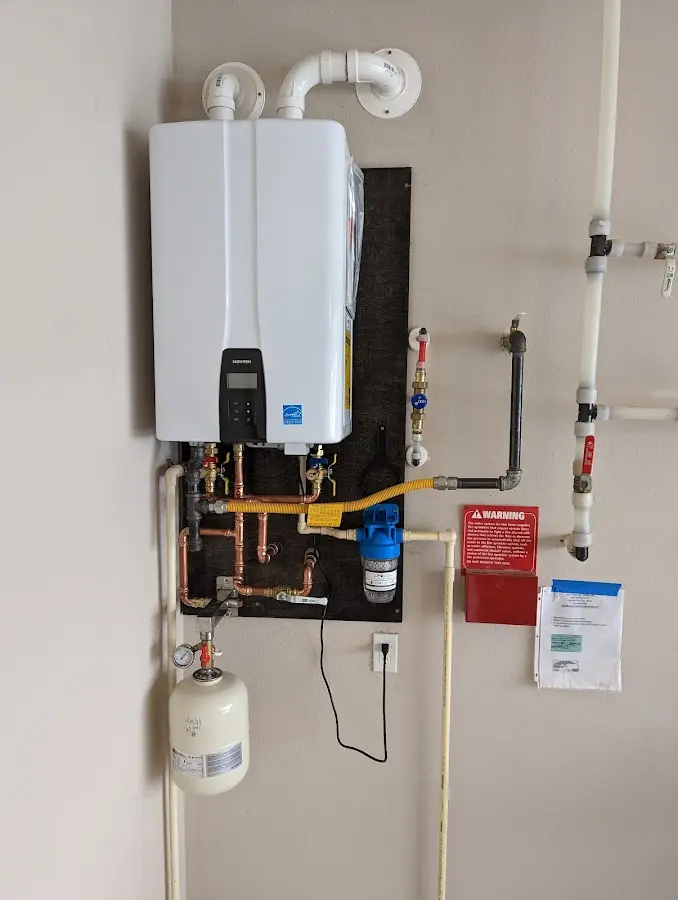Professional plumber installing copper piping in a Holyoke home